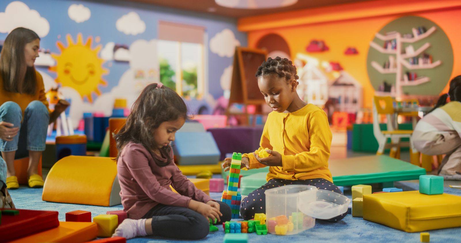 Two children building with blocks together
